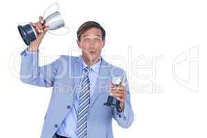 Happy businessman holding a trophy