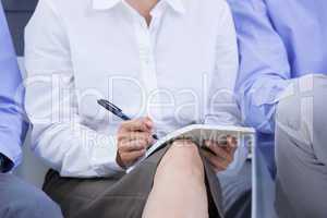 businesswomen taking a note during a meeting