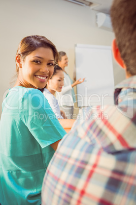 A young female designer listening to a conference