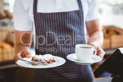 Smiling worker prepares breakfast