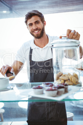 Smiling worker prepares breakfast