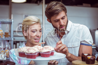 Cute couple on a date choosing cakes