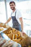 Smiling worker posing behind the counter