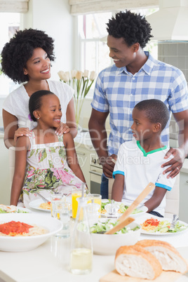 Happy family sitting down to dinner together