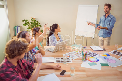 Casual businessman giving presentation to his colleagues