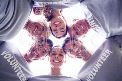 Happy volunteer family looking down at the camera