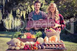 Happy farmers standing at their stall