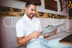 Young man reading a newspaper