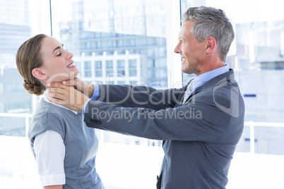 Businessman trying to smother his colleague