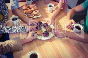 Business people taking cakes on table