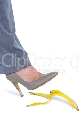 Woman with heel shoes walking on banana