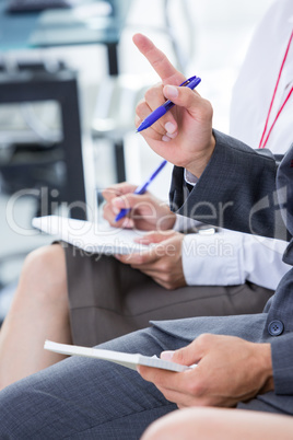 Businessman taking note during a meeting