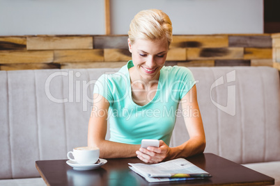 Pretty blonde woman using her smartphone Pretty blonde woman using her smartphone