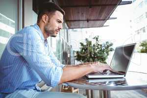 Attentive businessman using his laptop