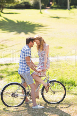 Young couple on a bike ride in the park