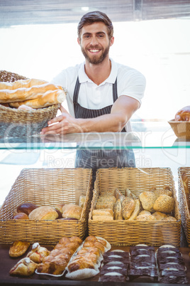 Smiling worker posing behind the counter