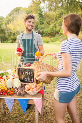 Brunette buying peppers at the farmers market