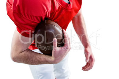 An maerican football player taking a ball on her hand