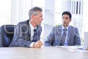 Businessman meeting withcolleague using laptop