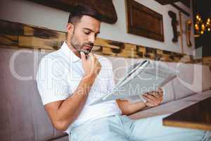 Young man reading a newspaper