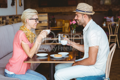 Cute couple on a date talking over a cup of coffee