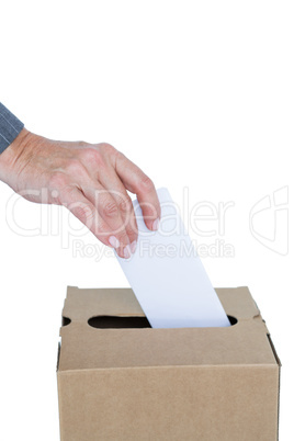 Businessman putting ballot in vote box