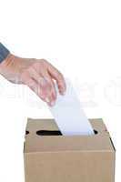 Businessman putting ballot in vote box