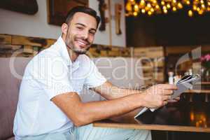 Young man reading a newspaper