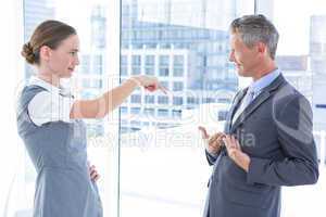 Business woman pointing her colleague