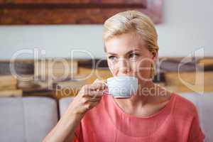 Pretty blonde holding cup of coffee