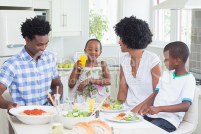 Happy family sitting down to dinner together