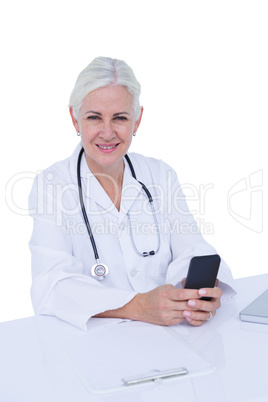 Thinking woman doctor phoning with her smartphone