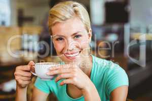 Pretty blonde holding cup of coffee