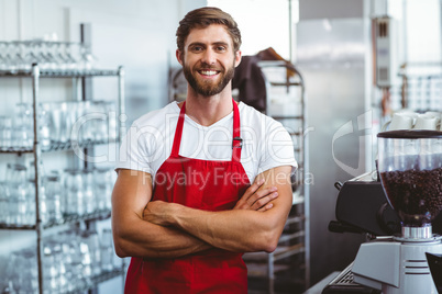 Handsome barista smiling at the camera