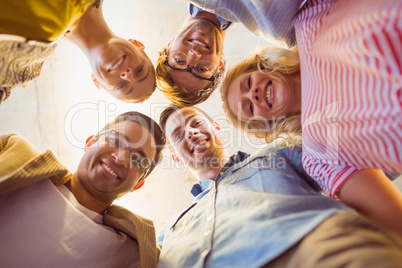 Business team standing in circle smiling at camera