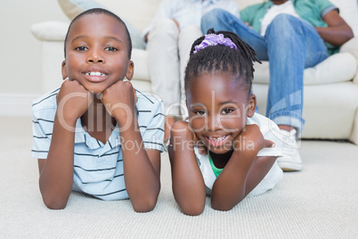 Happy siblings lying on the floor