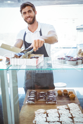 Smiling worker prepares orders