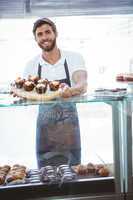 Smiling worker posing behind the counter