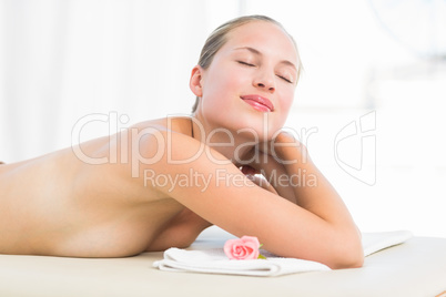 Peaceful blonde lying on towel