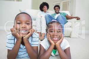 Happy siblings lying on the floor