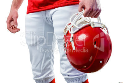 An american football player taking his helmet on her hand