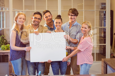 Business team holding a white cardboard