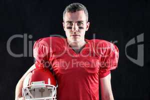 A serious american football player looking at camera