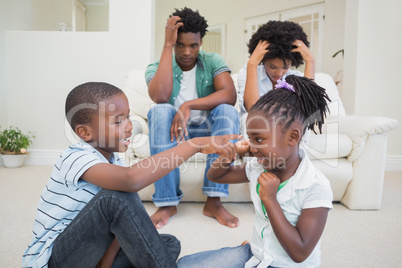 Frustrated parents watching their children fight