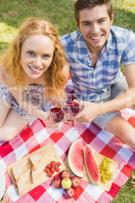 Young couple on a picnic drinking wine