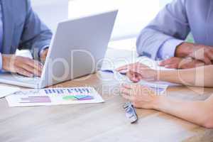 Colleagues with laptop and digital tablet in meeting