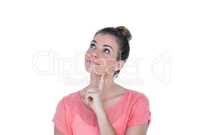 Thoughtful pretty casual brunette standing with hand on chin