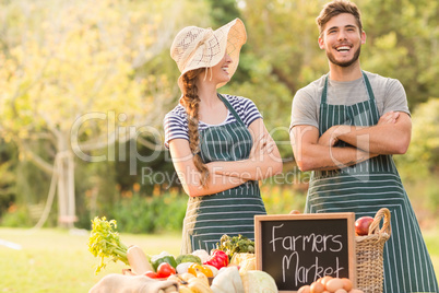 Happy farmers standing arms crossed