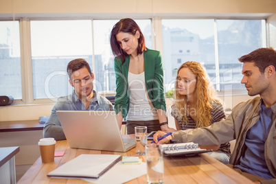 Group of young colleagues using laptop