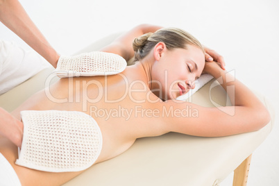 Peaceful blonde enjoying an exfoliating back massage